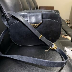 Cartier black crossbody. Slight scratches but fixable with handbag repair.